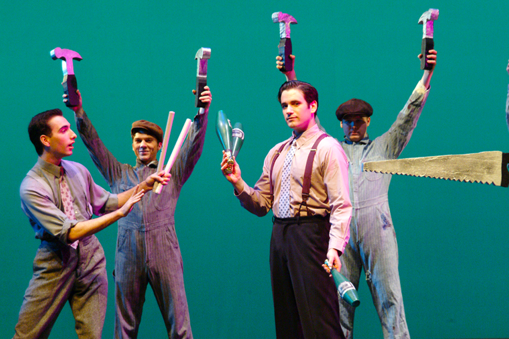 Colin Donnell holds juggling pins while surrounded by three other actors in Pal Joey 